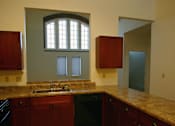 Thumbnail 22 of 27 - A kitchen with a sink and a window.