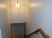 Thumbnail 12 of 13 - A staircase with a light hanging from the ceiling.