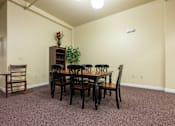 Thumbnail 10 of 17 - A dining room with a wooden table and chairs.