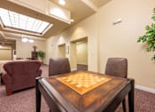 Thumbnail 12 of 17 - A room with a table and chairs and a ceiling light.