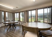 Thumbnail 4 of 20 - A dining room with a table and chairs.