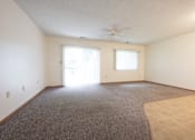 Thumbnail 4 of 14 - A room with a carpeted floor and a ceiling fan.