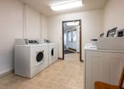 Thumbnail 13 of 14 - A room with a washer and dryer set up.