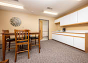 Thumbnail 11 of 14 - A dining area with a table and chairs.