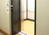 Thumbnail 20 of 30 - An elevator with the doors open to see the inside of the elevator