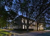 Thumbnail 22 of 22 - A building with a tree in front of it.