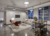 Thumbnail 6 of 22 - A modern living room with a white couch, a wooden table, and a rug.