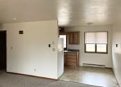 Thumbnail 4 of 9 - an empty house with a kitchen and a window