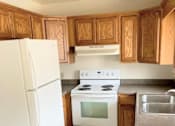 Thumbnail 6 of 9 - a kitchen with a white stove and a refrigerator