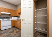 Thumbnail 14 of 21 - A kitchen with a white door and a white oven.