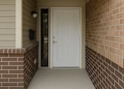 Thumbnail 3 of 11 - A white door is at the end of a hallway.