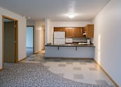 Thumbnail 5 of 11 - A kitchen with white appliances and wooden cabinets.