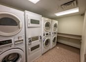 Thumbnail 18 of 19 - A row of washing machines in a public laundromat.