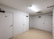 Thumbnail 4 of 14 - A white door with the number 404 on it is in a room with three other white doors.