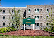 Thumbnail 1 of 14 - A sign in front of a building that says Courtview Apartments.