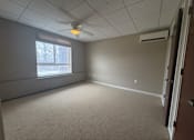 Thumbnail 20 of 28 - A room with a window and a ceiling fan.