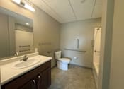 Thumbnail 21 of 28 - A bathroom with a toilet, sink, and bathtub.