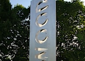Thumbnail 3 of 11 - A large metal sign with the letters E, S, T, I, M, G, O, N on it.