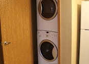 Thumbnail 11 of 11 - Two washing machines are installed in a cabinet.