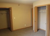 Thumbnail 8 of 11 - A room with a closet and a door.