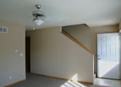 Thumbnail 7 of 11 - A room with a light on the ceiling and a door on the right.
