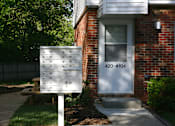 Thumbnail 2 of 11 - A white mailbox with the number 420-104 on it is in front of a brick house.