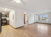 Thumbnail 13 of 20 - A spacious room with wooden floors and a ceiling fan.