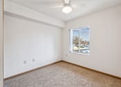 Thumbnail 17 of 20 - Empty room with a window showing an outdoor view.