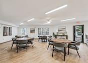 Thumbnail 5 of 20 - A room with a long table and chairs.