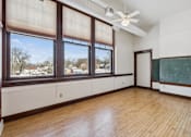 Thumbnail 13 of 17 - A room with a blackboard and a window overlooking a snowy landscape.