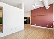 Thumbnail 11 of 17 - A room with a ceiling fan and a red wall.
