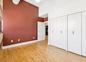 Thumbnail 12 of 17 - A room with white cupboards and a red wall.