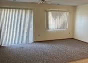 Thumbnail 6 of 13 - A room with a carpeted floor and a ceiling fan.