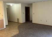 Thumbnail 3 of 13 - A room with a carpeted floor and a ceiling fan.