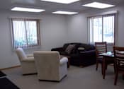 Thumbnail 2 of 15 - A living room with a couch, chairs, and a table.