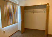Thumbnail 9 of 15 - A room with a closet and a door.