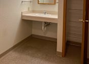 Thumbnail 11 of 15 - A bathroom with a sink and mirror.