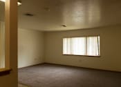 Thumbnail 6 of 10 - A room with a window and carpeted floor.