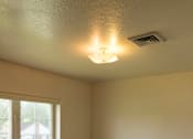 Thumbnail 7 of 10 - A room with a window and a ceiling light.
