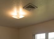 Thumbnail 8 of 10 - A room with a window and a ceiling light.