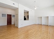 Thumbnail 4 of 27 - A room with wooden floors and white walls.