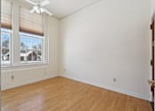 Thumbnail 3 of 27 - A room with a ceiling fan and a window with blinds.