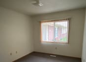 Thumbnail 4 of 6 - A room with a window and a wall on the right side.