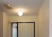 Thumbnail 7 of 12 - A white door is open to a hallway.