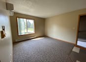 Thumbnail 8 of 13 - A room with a window and a door.