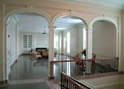 Thumbnail 2 of 17 - A large open room with arches and a balcony.