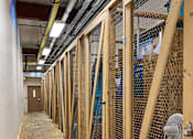 Thumbnail 17 of 17 - A long hallway with wooden framing and a fan on the floor.