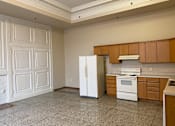 Thumbnail 8 of 17 - A kitchen with a white refrigerator and a white stove top oven.