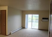 Thumbnail 4 of 12 - A room with a sliding glass door leading to a balcony.