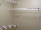 Thumbnail 11 of 12 - A white shelving unit with three shelves is in a corner.